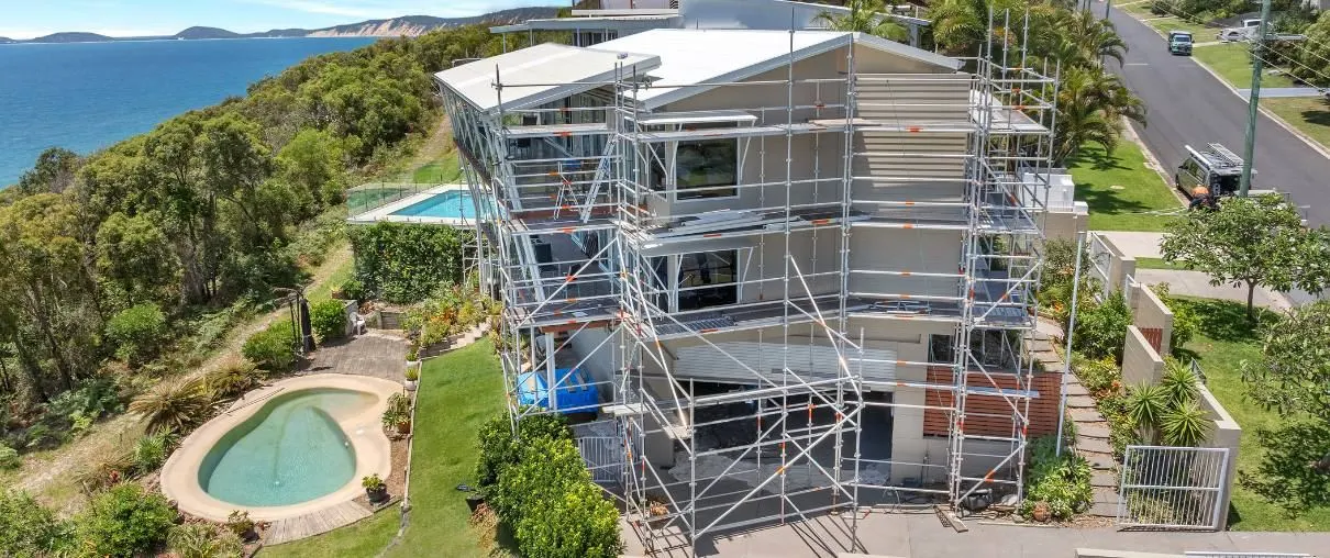 Two-storey home under construction with scaffolding